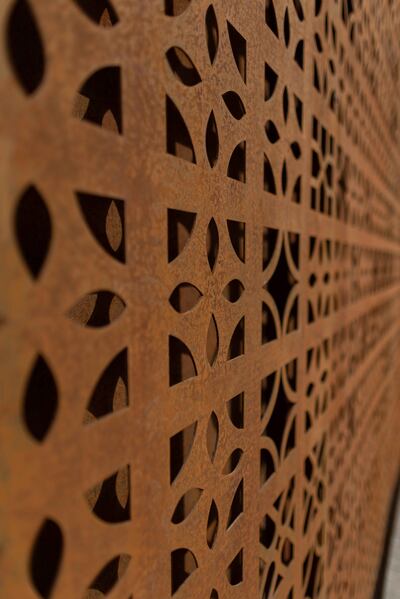 The building's design transposes the patterns of concrete breeze blocks into Corten steel. Photo: RCU