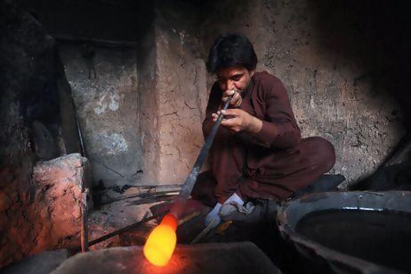 A glassblower in a Herat workshop. Aref Karimi / AFP