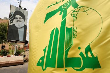 A Hezbollah flag and a poster depicting the group's leader Hassan Nasrallah. Reuters