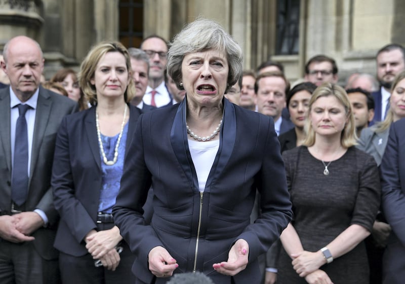 Britain's new Conservative Party leader Theresa May (C) speaks to members of the media at The St Stephen's entrance to the Palace of Westminster in London on July 11, 2016. - Theresa May will on Wednesday become the prime minister who leads Britain's into Brexit talks after her only rival in the race to succeed David Cameron pulled out unexpectedly. May was left as the only contender standing after the withdrawal from the leadership race of Andrea Leadsom, who faced criticism for suggesting she was more qualified to be premier because she had children. (Photo by DANIEL LEAL-OLIVAS / AFP)