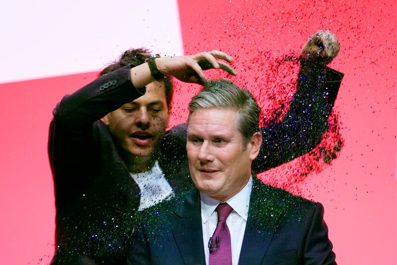 Mr Starmer was wearing a navy suit when he was covered in glitter by a protestor at the Labour Party conference in 2023