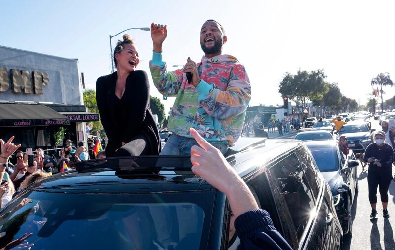 WEST HOLLYWOOD, CALIFORNIA - NOVEMBER 07: John Legend and Chrissy Teigen celebrate President-Elect Joe Biden's projected win with a drive-by on November 07, 2020 in West Hollywood, California. (Photo by Amanda Edwards/Getty Images)