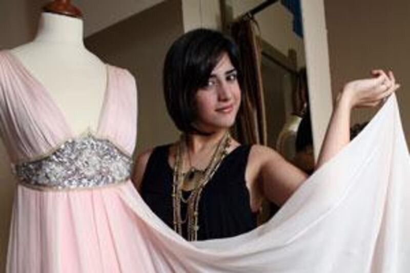 Aiisha Ramadan, shows off one of her dresses at her store, Corset Fashions, in Sharjah.