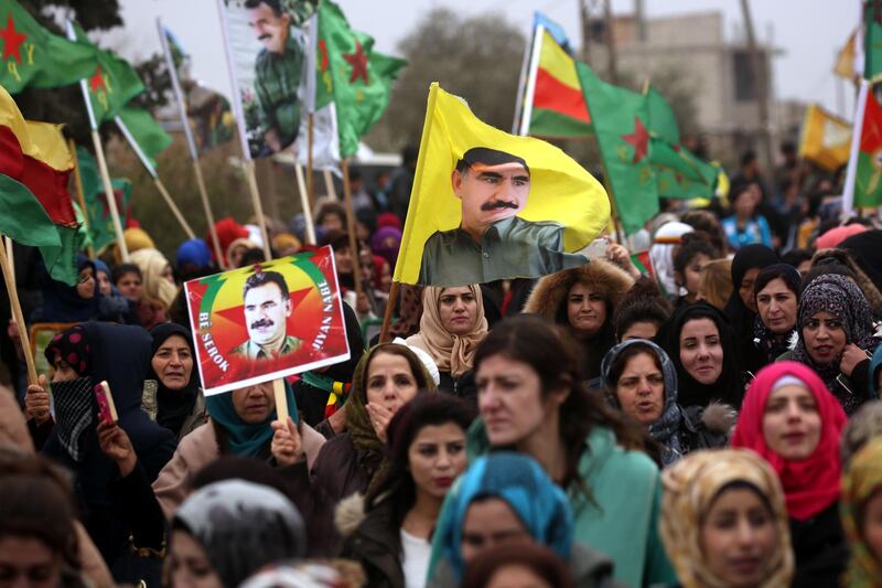 TOPSHOT - Syrian-Kurds carry portraits depicting jailed founding member and leader of the Kurdistan Worker's Party (PKK) Abdullah Ocalan, as they march during a protest in support of Afrin on January 18, 2018, in the northern Syrian town of Jawadiyah.
Turkish President Recep Tayyip Erdogan earlier in the week vowed to soon launch an operation against towns in Syria held by the Kurdish People's Protection Units (YPG), which Ankara considers "terrorists". / AFP PHOTO / Delil souleiman