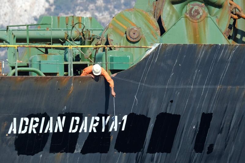  (FILES) In this file photo taken on August 18, 2019 a crew member checks the new name of Iranian oil tanker Adrian Darya, formerly known as Grace 1, off the coast of Gibraltar. The United States on August 30, 2019, sanctioned an Iranian oil tanker previously held for weeks by Gibraltar and released despite Washington's efforts to keep it detained. The US Department of Treasury said the vessel, previously known as the Grace 1, is "blocked property" under an anti-terrorist order, and "anyone providing support to the Adrian Darya 1 risks being sanctioned."
 / AFP / Johnny BUGEJA
