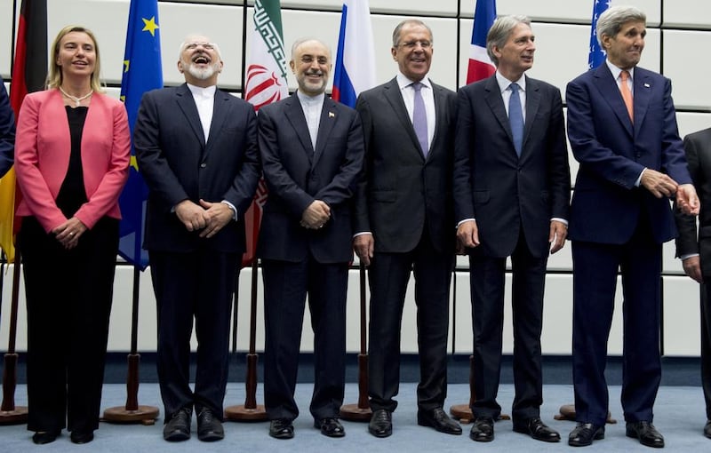 From left, the European Union high representative, Federica Mogherini; the Iranian foreign minister, Mohammad Javad Zarif; head of the Iranian Atomic Energy Organisation, Ali Akbar Salehi, the Russian foreign Minister Sergey Lavrov; the British foreign secretary Philip Hammond; and the US secretary of state John Kerry pose for a group picture at the United Nations building in Vienna after striking a landmark nuclear deal. Joe Klamar / Pool Photo via AP