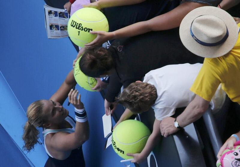 Dominika Cibulkova of Slovakia signs autographs after her giant-killing run at Melbourne came to an end. David Gray / Reuters