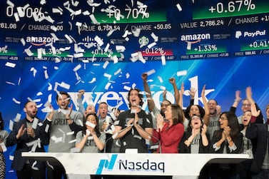 In this Jan. 16, 2018 file photo, Adam Neumann, center, co-founder and CEO of WeWork, attends the opening bell ceremony at Nasdaq in New York. WeWork's parent company is revealing more of its initial public offering plans, saying it expects to list shares on the Nasdaq. AP