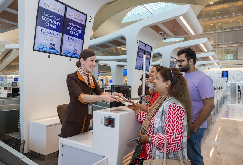 Etihad Airways welcomes the first passengers to check in at Terminal A. The airport is being renamed Zayed International Airport. All photos Etihad Airways