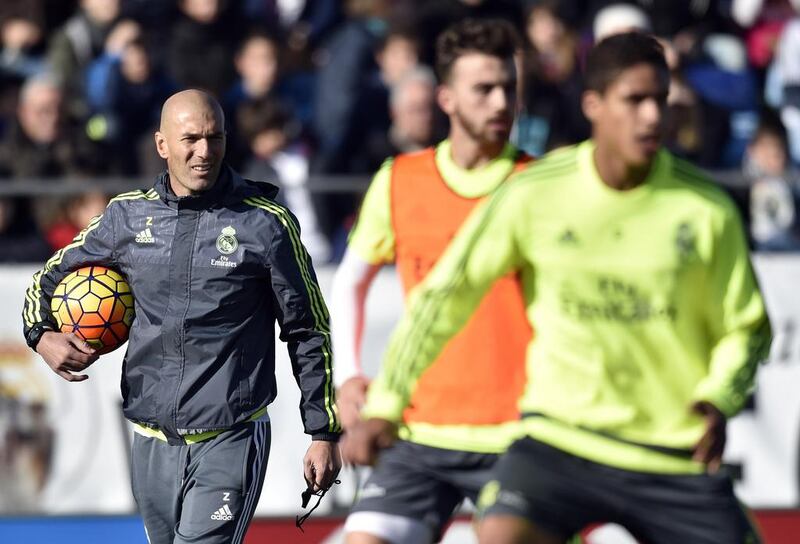 Real Madrid’s new coach Zinedine Zidane, left, watches his players during his first training session at the Alfredo di Stefano Stadium. Gerard Julien / AFP