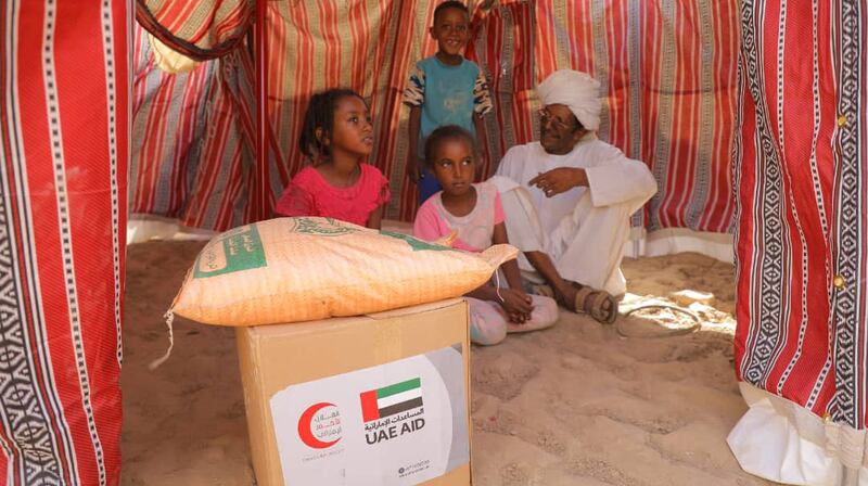 A family in Sudan receives an aid package. Wam