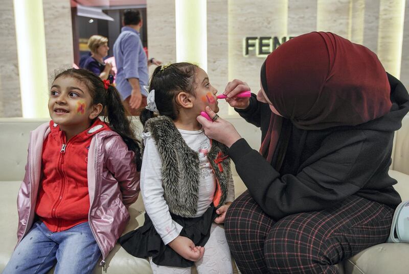 Abu Dhabi, United Arab Emirates, December 31, 2019.  Mrs. Fayed face paints her children for NYE celebrations at the Galleria Mall, Al Maryah Island.      Victor Besa / The National
Section:  NA
Reporter:  Saeed Saeed