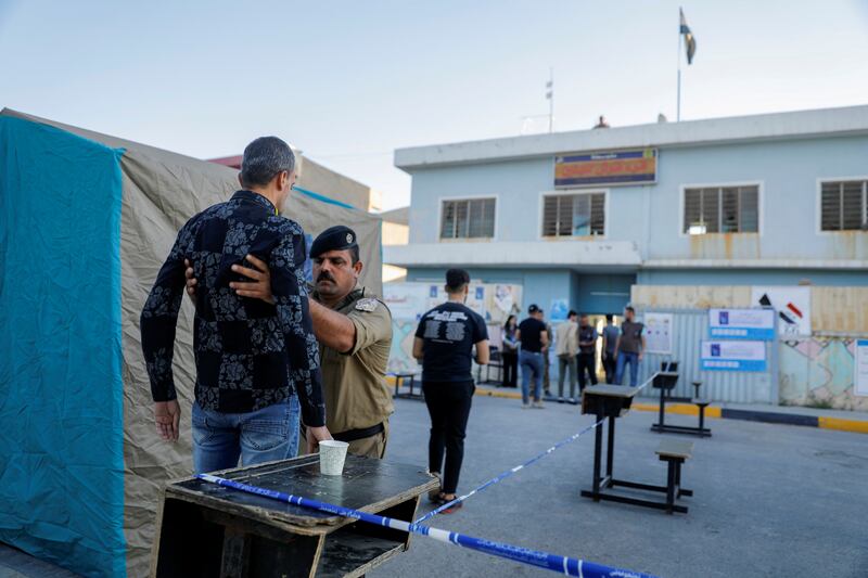 People undergo security checks before gaining entry to a polling station in Qaraqosh, Nineveh governorate. Photo: Reuters