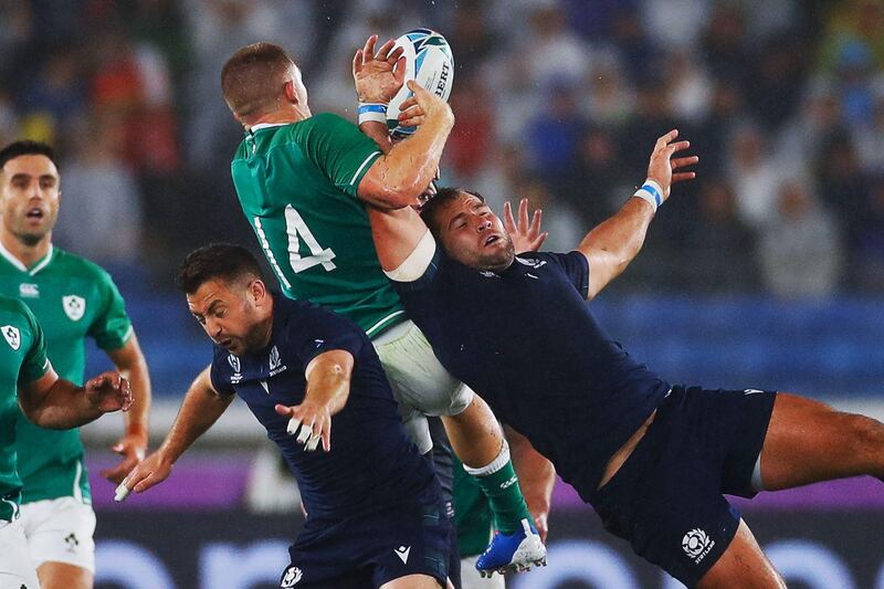 Ireland wing Andrew Conway, centre, jumps for the ball in Yokohama. AFP