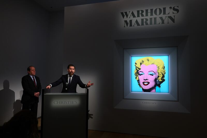 Christie’s Americas chairman Marc Porter, left, and Alex Rotter, Christie's chairman of 20th and 21st Century Art, as the auction house announces that it will put Andy Warhol’s 'Shot Sage Blue Marilyn' painting under the hammer on Monday. AFP