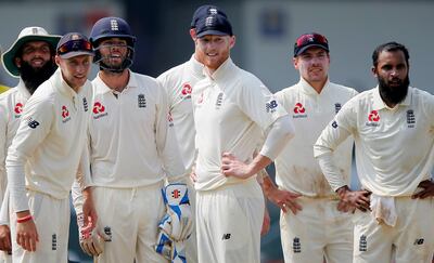 FILE PHOTO: Cricket - England v Sri Lanka, Third Test - Colombo, Sri Lanka - November 26, 2018. England's captain Joe Root (2nd L), Moeen Ali (L), Ben Foakes (3rd L), Ben Stokes (C), Rory Burns (2nd r) and Adil Rashid watch the run out of the Sri Lanka's Kusal Mendis (not pictured) on a screen. REUTERS/Dinuka Liyanawatte/File Photo