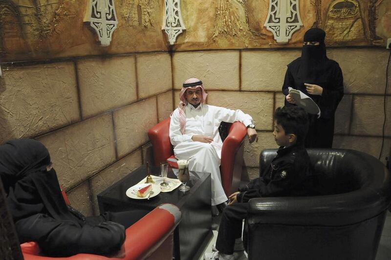 A veiled Saudi waitress speaks to visitors at a coffee shop in Tabuk. Of the 4.4 million jobs created in the 2003 through 2013 decade of booming oil prices and prosperity, about 1.7 million, 39 per cent, were taken by Saudis, according to the McKinsey Global Institute. Mohamed Alhwaity / Reuters