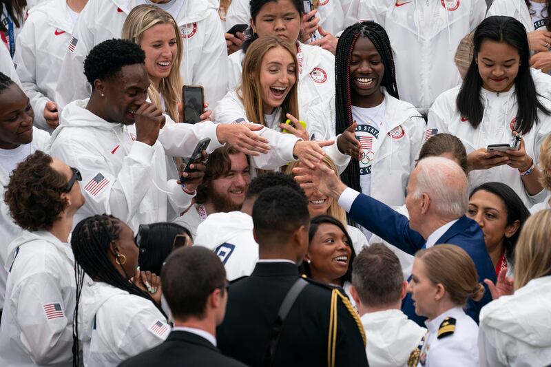 President Joe Biden shakes hands with members of Team USA during an event on the South Lawn of the White House. AP