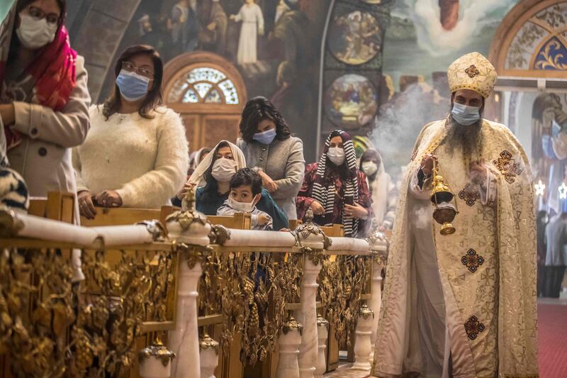 A priest leads Christmas Mass at the Archangel Michael Coptic Orthodox Church. Many Orthodox Christians celebrate Christmas on or near January 7, as their churches follow the Julian calendar. AFP