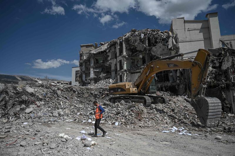 An excavator removes the rubble of collapsed buildings in the quake-hit city of Kahramanmaras, Turkey. AFP