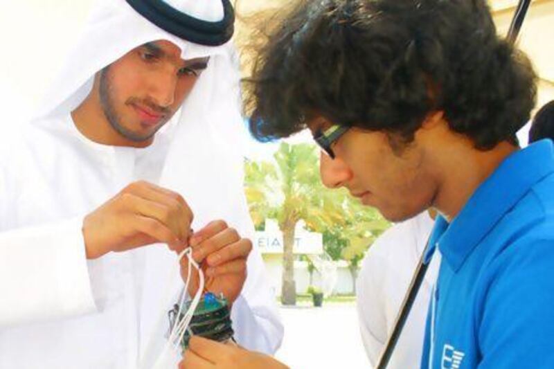 Khalid Zowayed, an assistant researcher at Eiast, demonstrating a CanSat to a student during a visit by the Omar bin Al Khattab Model School for boys to Eiast’s headquarters in Al Khawaneej. Courtesy EIAST
