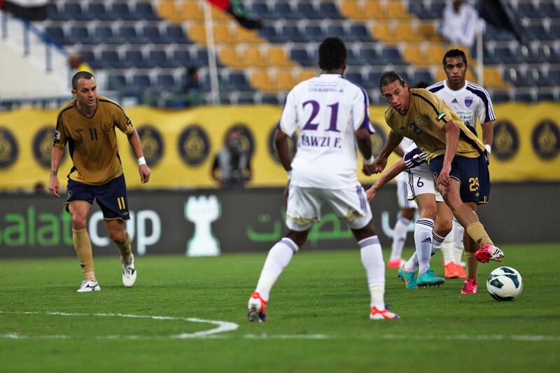 Dubai, UAE, October 10, 2012:

Richard Porta, Dubai's pony-tailed striker, is the subject of a player profile for the sports section of The National.
He is seen here on the night his squad lost to Al Ain, passing the ball to a team mate.



Lee Hoagland/The National