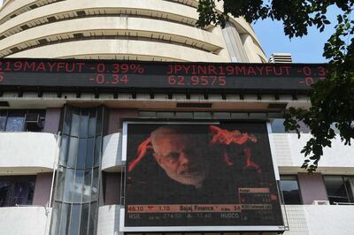 A digital broadcast shows an image of Indian Prime Minister Narendra Modi next to stock prices outside the Bombay Stock Exchange (BSE) in Mumbai on May 23, 2019. Indian stocks jumped to a record highs May 23 as early results in the world's biggest election showed Prime Minister Narendra Modi on course for a second term.

 / AFP / PUNIT PARANJPE                      

