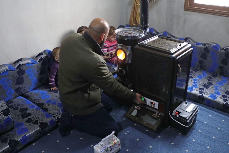 Abu Walid adjusts the temperature of a pistachio-powered heater with a dial regulating the number of shells burned per minute. AFP