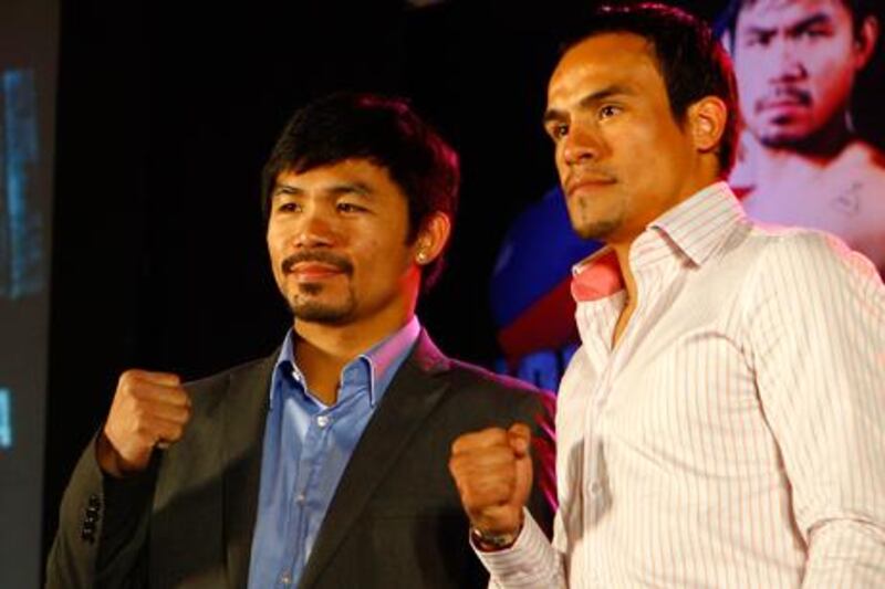 Manny Pacquiao and Juan Manuel Marquez promoting their 2011 bout.  Plans for a fifth fight this year are now in doubt.