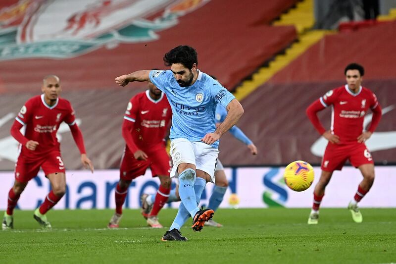 Manchester City's Ilkay Gundogan takes a penalty shot and fails to score during the English Premier League soccer match between Liverpool and Manchester City at Anfield Stadium, Liverpool, England, Sunday, Feb. 7, 2021. (Laurence Griffiths/Pool via AP)