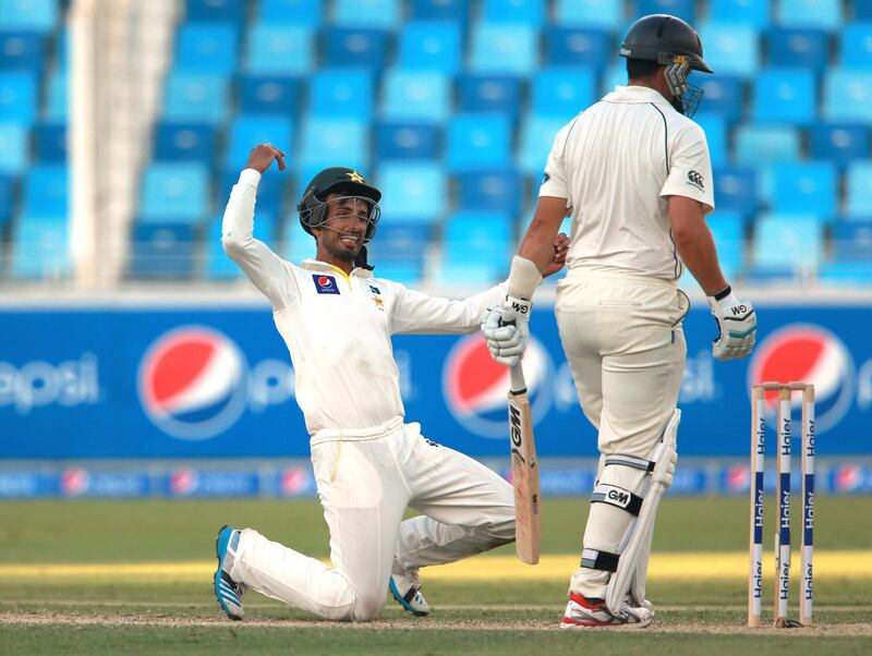 DUBAI, UNITED ARAB EMIRATES - NOVEMBER 17:  Shan Masood of Pakistan celebrates catching Ross Taylor of New Zealand off the bowling of Yasir Shar during day one of the second test between Pakistan and New Zealand at Dubai International Stadium on November 17, 2014 in Dubai, United Arab Emirates.  (Photo by Warren Little/Getty Images)