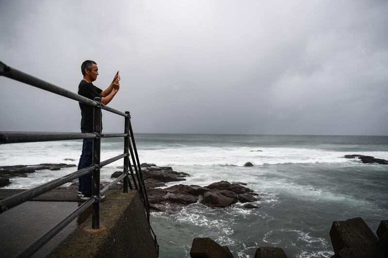 A man takes pictures of the coast as Typhoon Haishen approaches in Makurazaki, Kagoshima prefecture. AFP