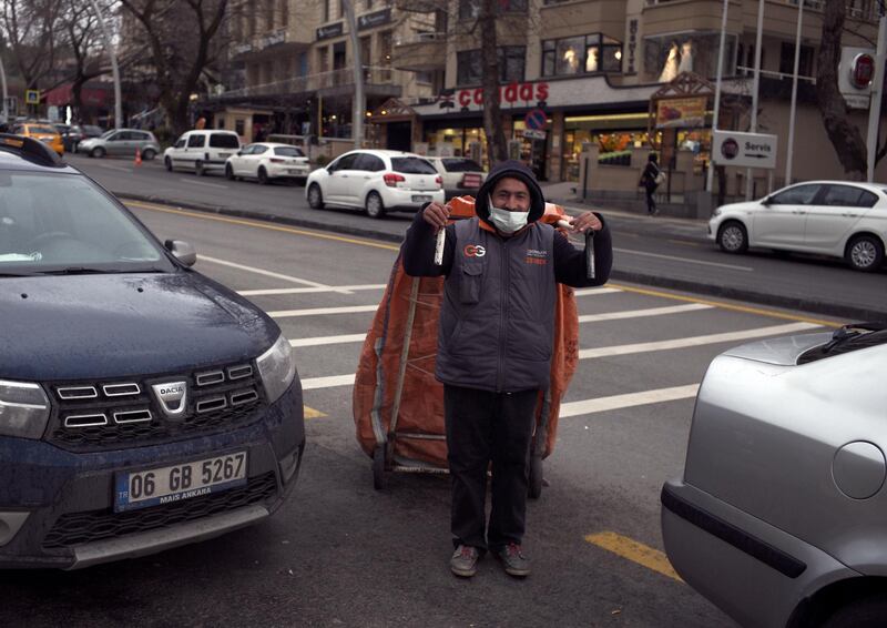 A garbage collector wearing a mask to help protect against the spread of coronavirus, pulls his cart in Ankara, Turkey. The number of confirmed daily COVID-19 infections in Turkey surpassed 40,000 on Thursday, hitting a record-high for a third straight day. The Health Ministry reported 40,806 new cases in past 24 hours, the highest since the start of the outbreak. It also reported 176 deaths, pushing the fatality toll to 31,713. AP Photo