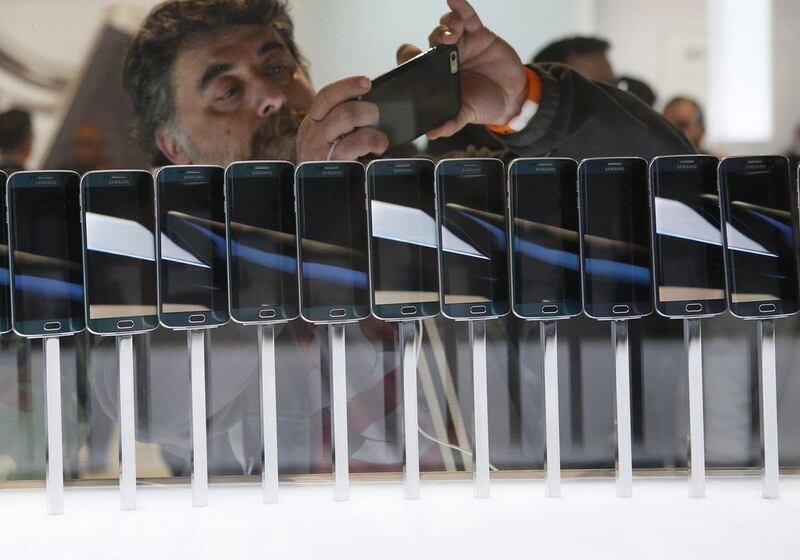 A row of Galaxy S6 edge smartphones are seen on display at the Samsung Galaxy Unpacked event at the Mobile World Congress. Albert Gea / Reuters