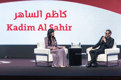 Moderator and TV presenter Nada Al Shaibani with Kadim Al Sahir at the Sharjah International Book Fair. Antonie Robertson / The National