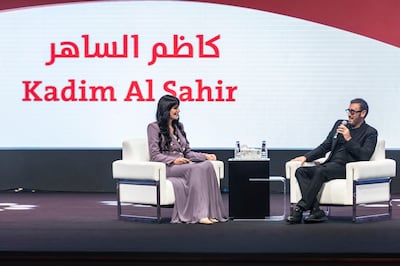 Moderator and TV presenter Nada Al Shaibani with Kadim Al Sahir at the Sharjah International Book Fair. Antonie Robertson / The National