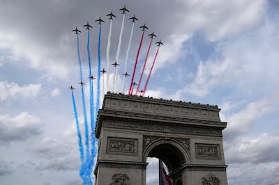 Jets of the Patrouille de France and the Red Arrows fly over the Arc de Triomphe. (AP Photo / Michel Euler)