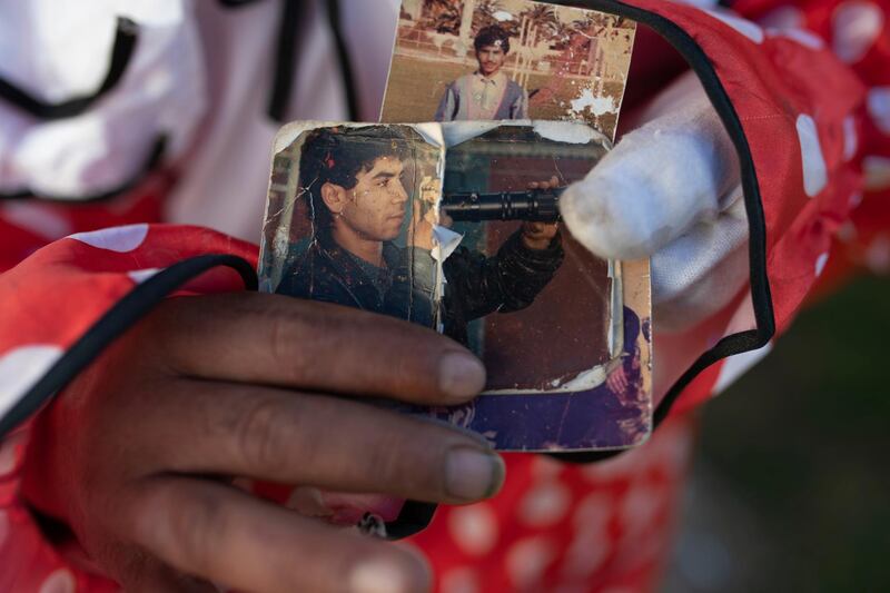 Belhussein Abdelsalam, shows pictures of himself as a young man. He lost his job as a sports photographer and was arrested three decades ago. AP Photo