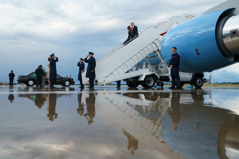 US President Donald Trump and first lady Melania Trump arrive on a wet tarmac on Air Force One, in Andrews Air Force Base, Maryland. Carolyn Kaster/AP Photo