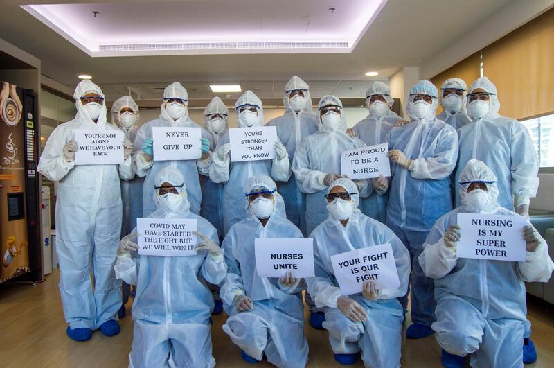 A group of nurses at a dedicated hospital in Sonapur, Dubai, that has reopened care specifically for moderate to severe Covid-19 patients. The nurses hold up signs to show their support to patients. They chat with patients to give them strength while also monitoring and treating those admitted. Courtesy: Aster DM Healthcare