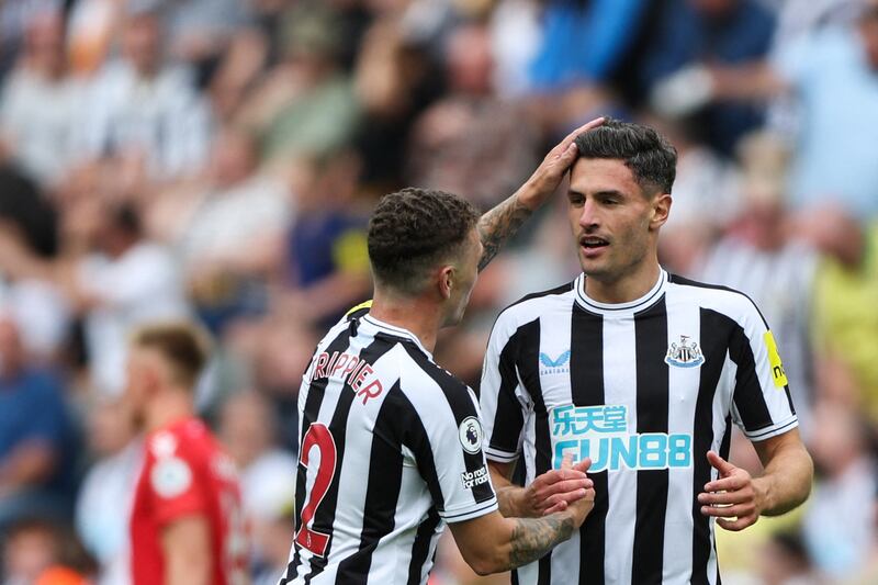Newcastle United's Swiss defender Fabian Schar celebrates with Kieran Trippier after opening the scoring against Nottingham Forest. AFP