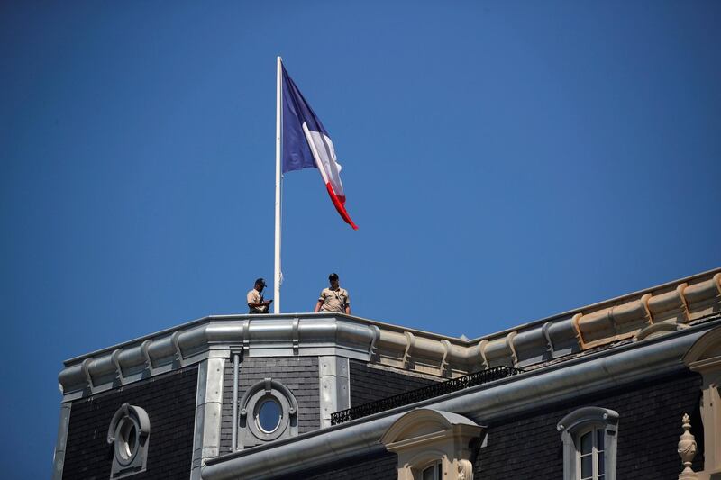 Security members are seen on top of the Hotel du Palais summit venue ahead of the G7 summit in Biarritz, France. Reuters