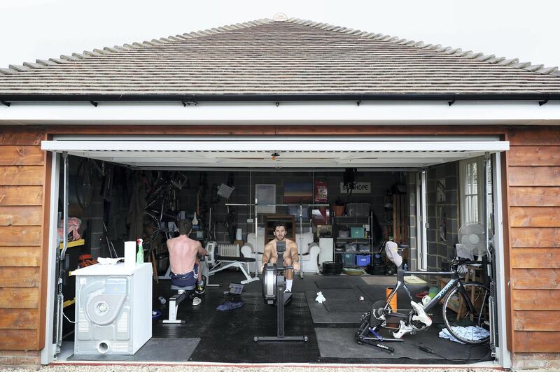 CAVERSHAM, ENGLAND - APRIL 01: Brothers Oliver Stanhope (left) and James Stanhope (right) train in their garage at home on April 01, 2020 in Caversham, England. The coronavirus and the disease it causes, COVID-19, are having a fundamental impact on society, government, sports and the economy in United Kingdom. As all sports events in United Kingdom have been cancelled athletes struggle to continue their training as usual. (Photo by Naomi Baker/Getty Images)