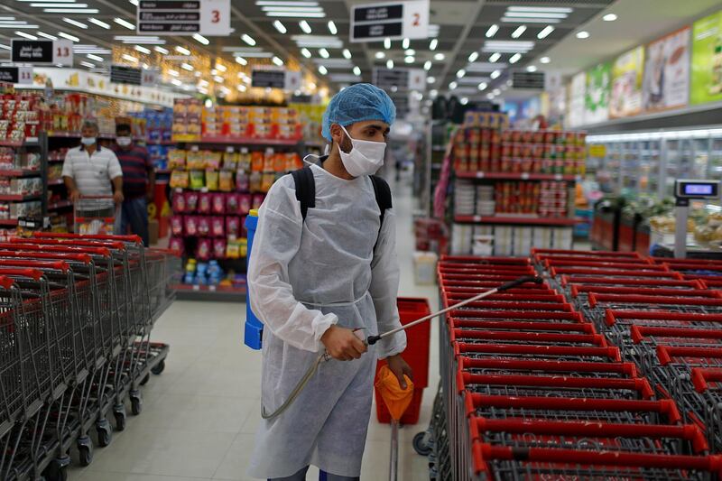 A Palestinian worker sanitises shopping carts in a mall that reopened partially amid the coronavirus crisis, in Gaza City on September 20, 2020. Reuters