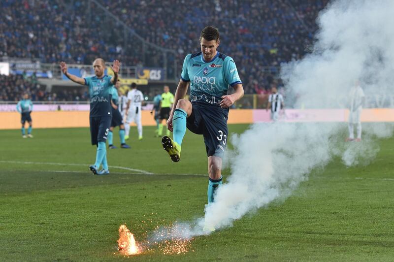 Hans Hateboer of Atalanta kicks a firework launched on the pitch during the Serie A match between Atalanta BC and Juventus at Stadio Atleti Azzurri d'Italia in Bergamo, Italy.  Getty Images