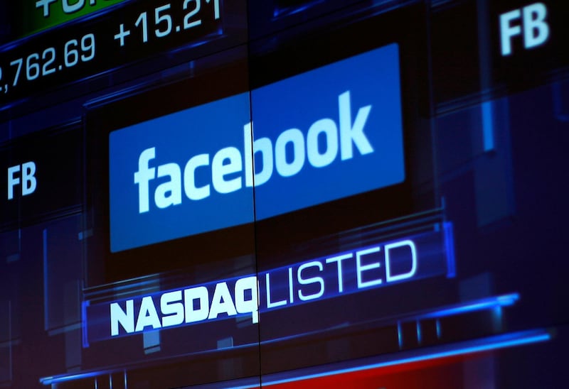 FILE PHOTO: Monitors displays the Facebook, Inc. stock during morning trading at the NASDAQ Marketsite in New York, NY, U.S., June 4, 2012. REUTERS/Eric Thayer/File Photo