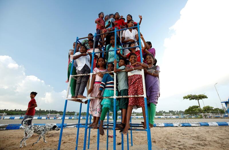 Children staying in the care home set up by Karibeeran Paramesvaran and his wife Choodamani after they lost three children in the 2004 tsunami, pose in a park along a beach in Nagapattinam district in the southern state of Tamil Nadu, India. REUTERS