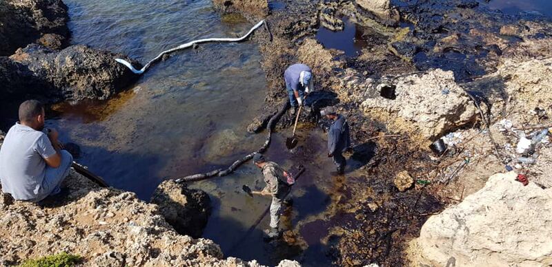 People cleaning Syria's Mediterranean coast following an oil leak from the Baniyas power plant. AFP