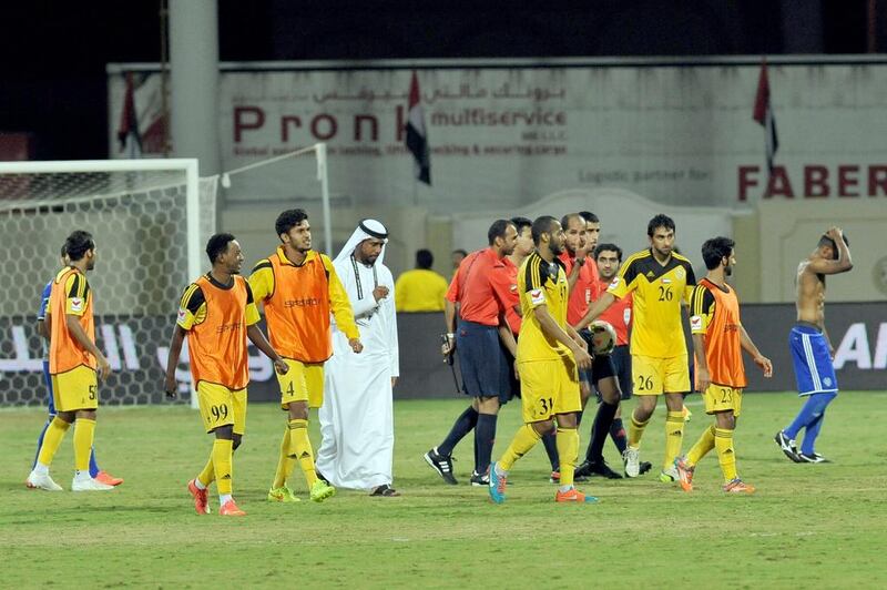 The Kalba camp in celebration after handing out a shock defeat to Al Nasr, in blue. Courtesy Mohideen / Al Ittihad

