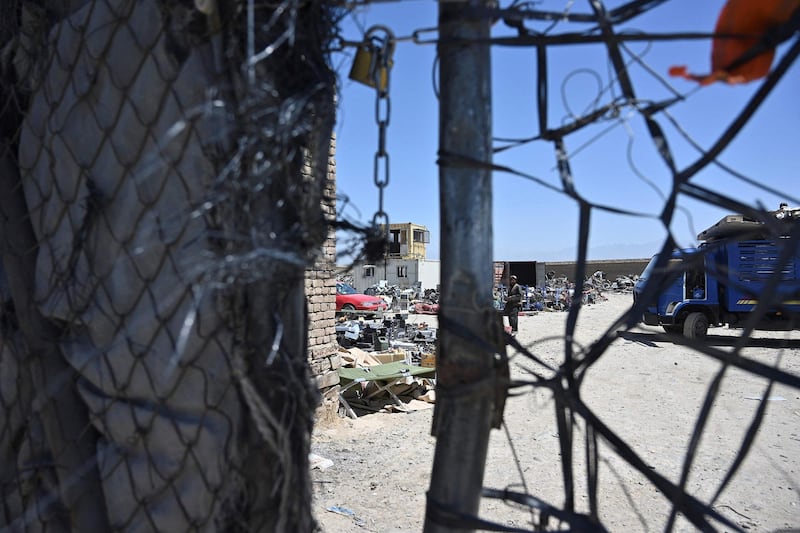 A man stands at a junkyard near the Bagram Air Base. AFP